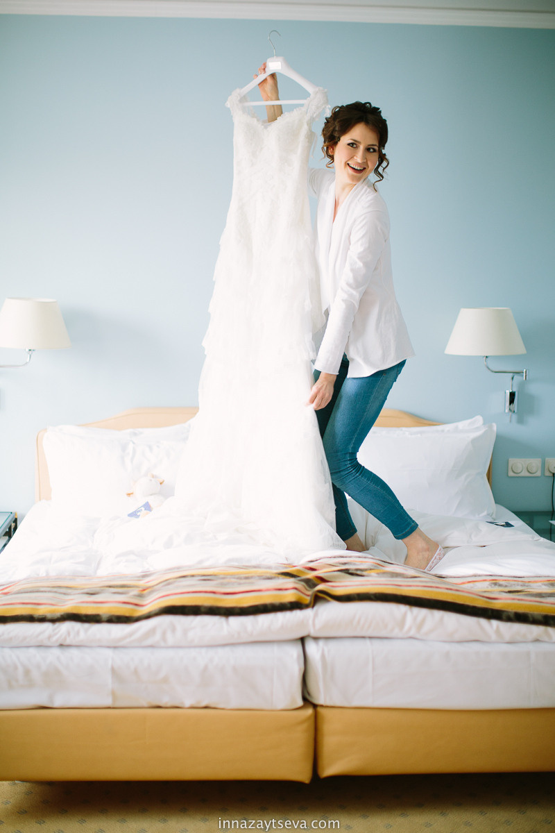 the bride is dancing with a wedding dress in posing for wedding photographer in Bad Homburg