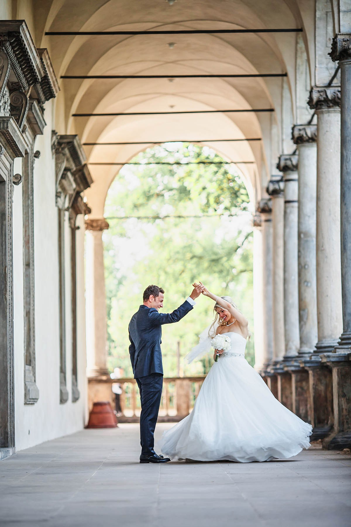 Groom spinning bride during portrait session at Belvedere Prague