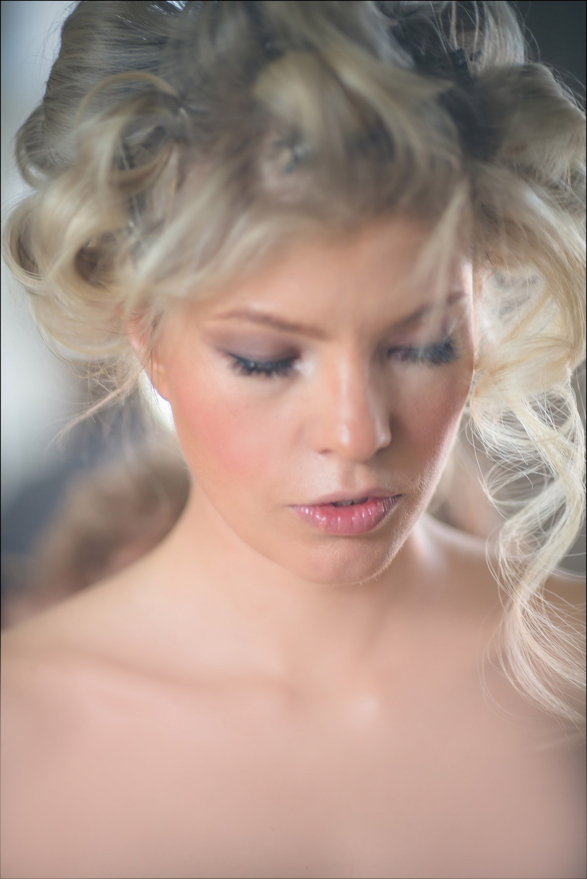 Hairstylist creating bridal look for blonde Swiss bride Julia at Augustine Hotel Prague