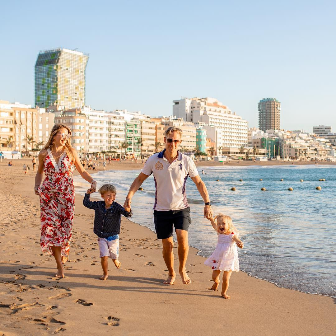 A family walking on the beach with their children Las Palmas