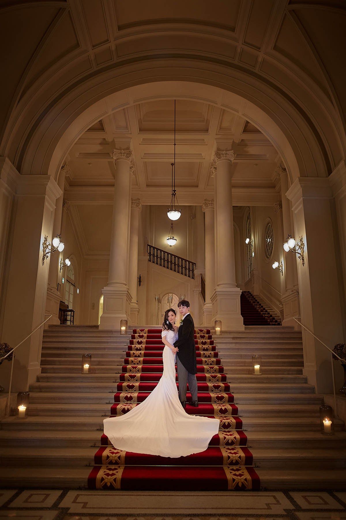 Newlyweds candlelit portrait in hall Palais Coburg Vienna.