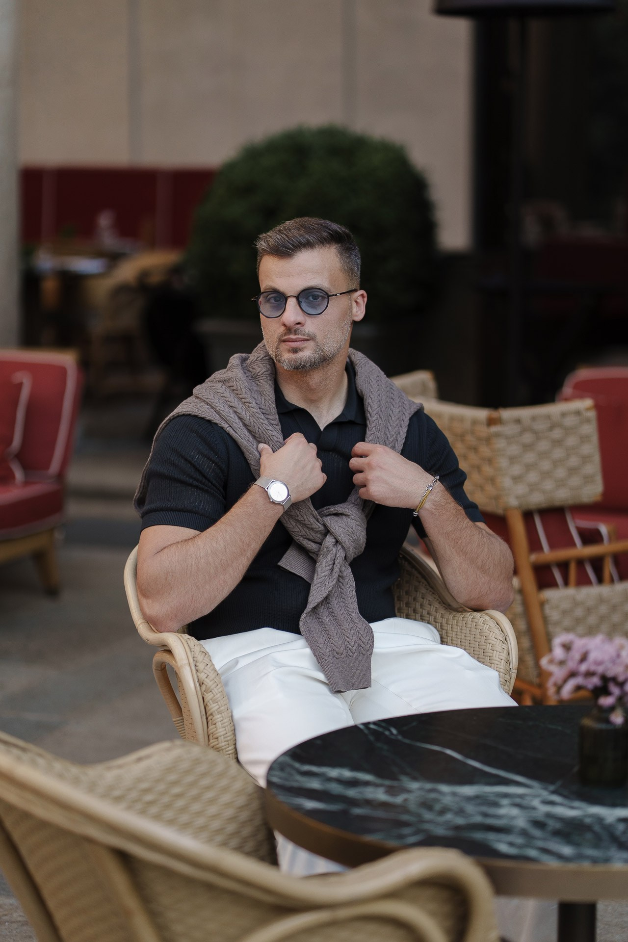 Jamal seated at an outdoor cafe during a lifestyle photoshoot in Milan