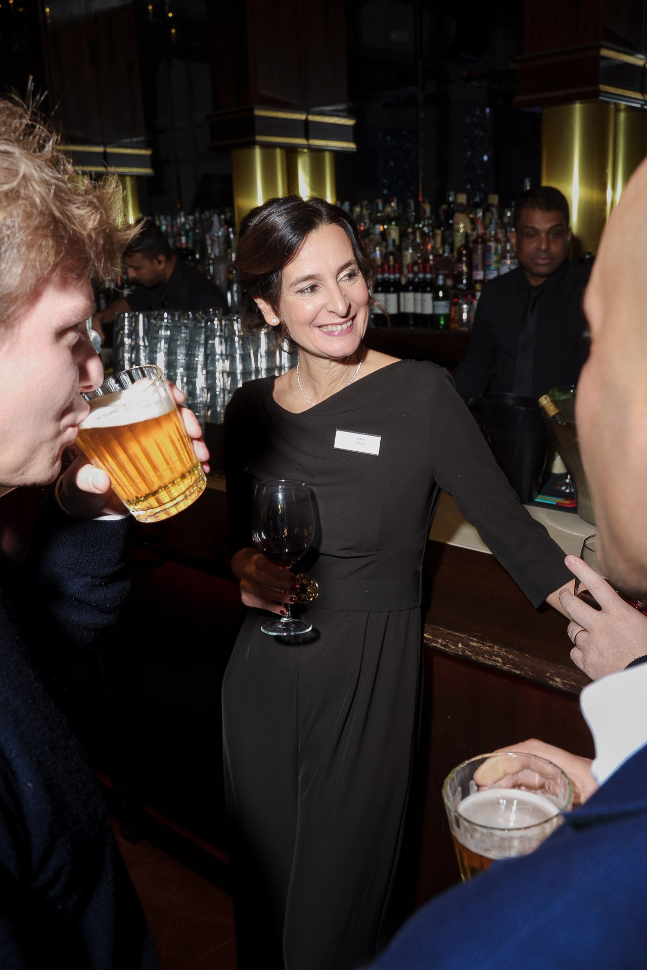 Candid guest portrait at a corporate gala dinner in Milan, showing professional networking atmosphere.