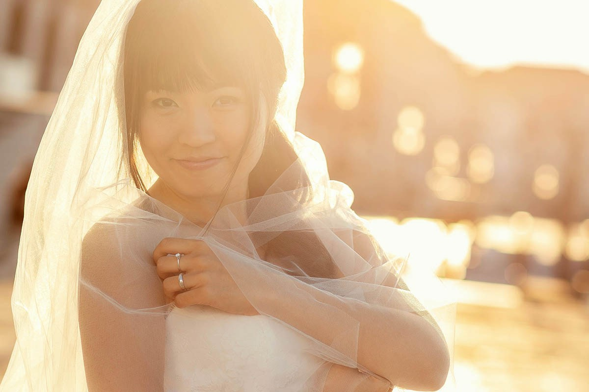 Engagement portrait of a young Hong Kong bride bathed in golden early morning sunshine, Venice - Kurt Vinion Photography
