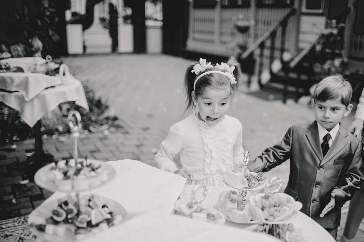 Candid moment of kids looking at table served with sweets