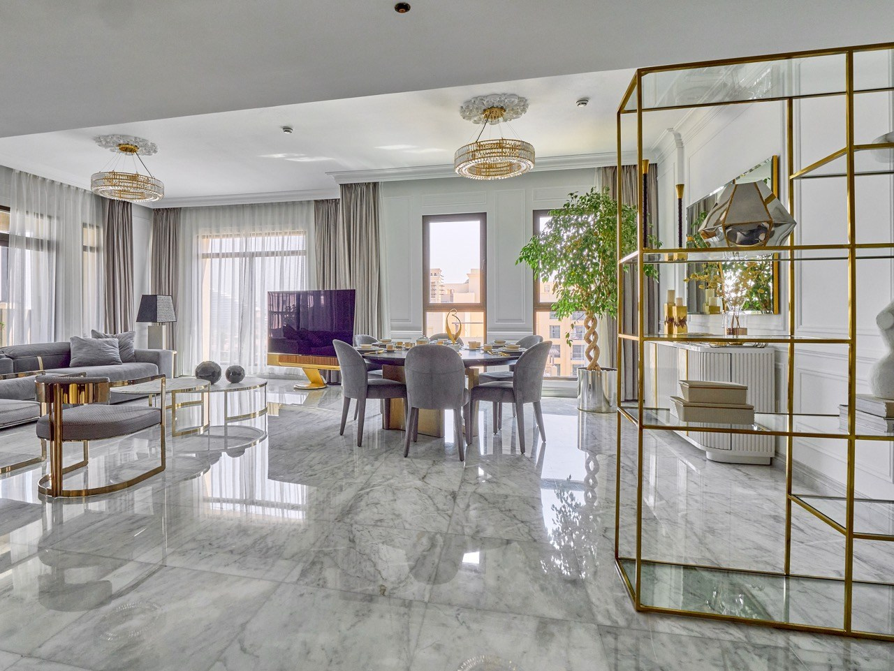 Open-plan living and dining room with marble floor and gold accents, captured by architecture and Airbnb photographer.