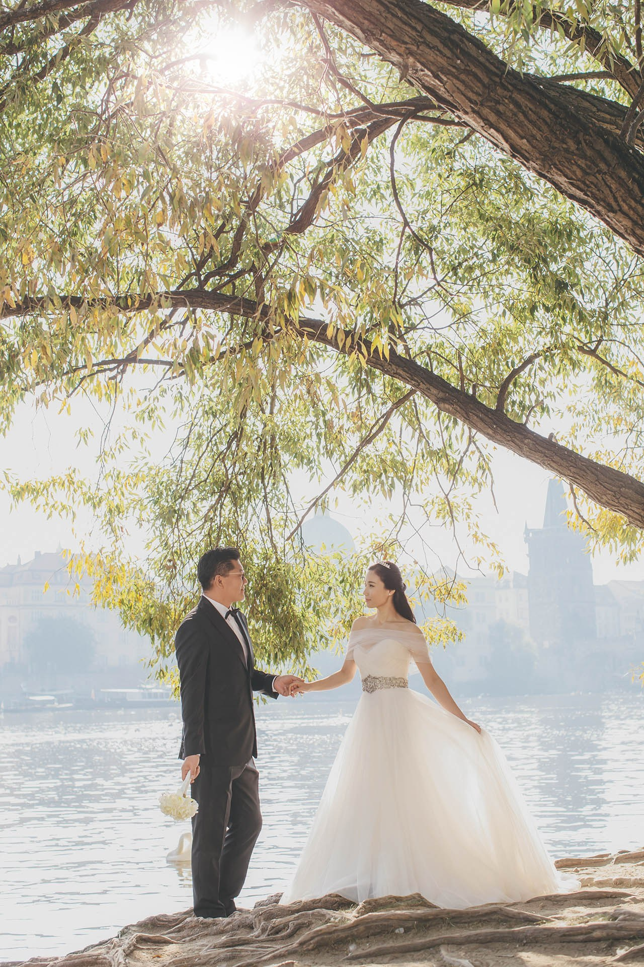 Catherine Cedric Son riverside swans hand hold Prague portrait.