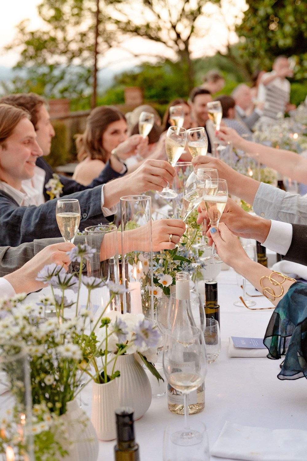 Guests celebrating at outdoor wedding reception in Tuscany