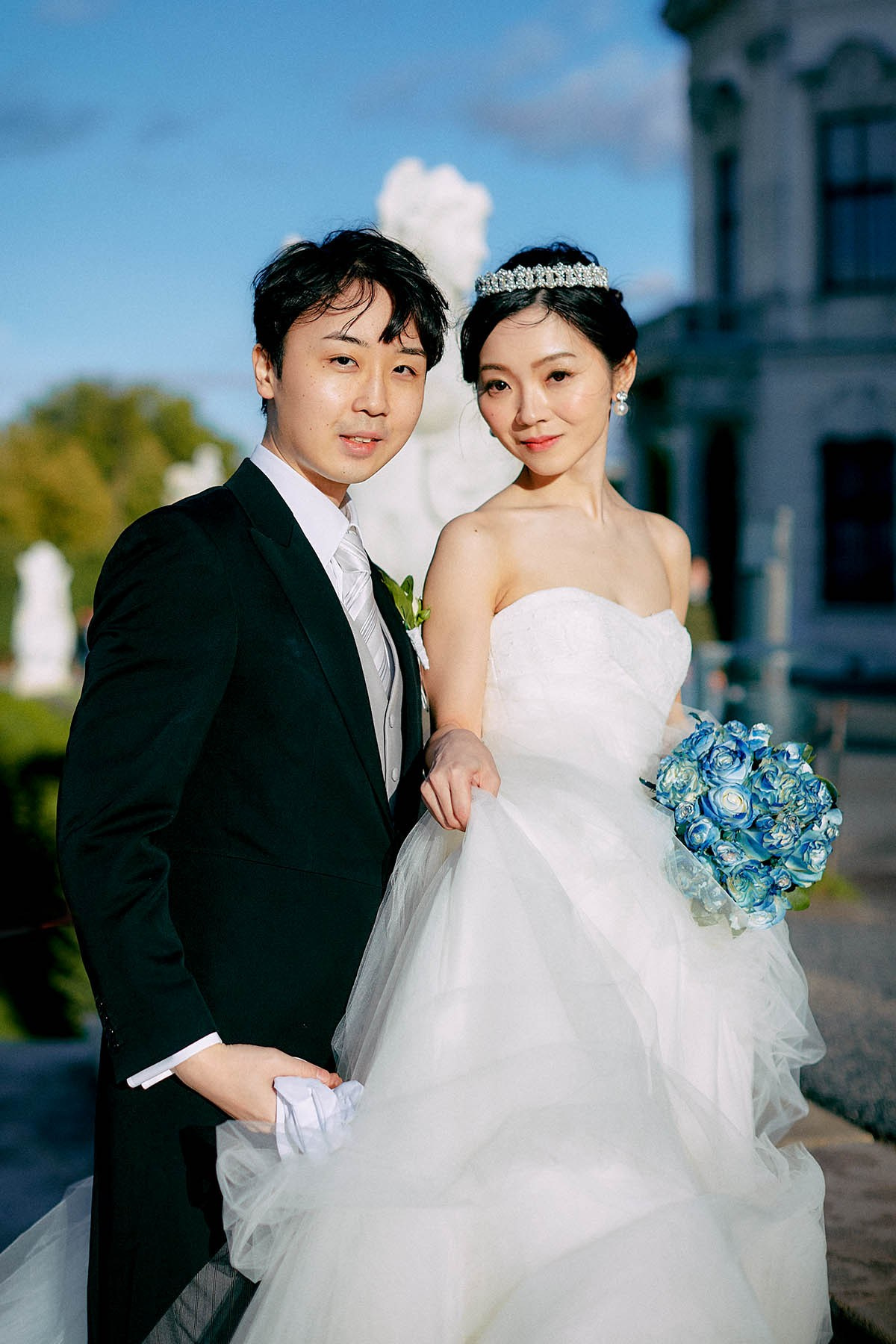 Newlyweds faces lit by sun.