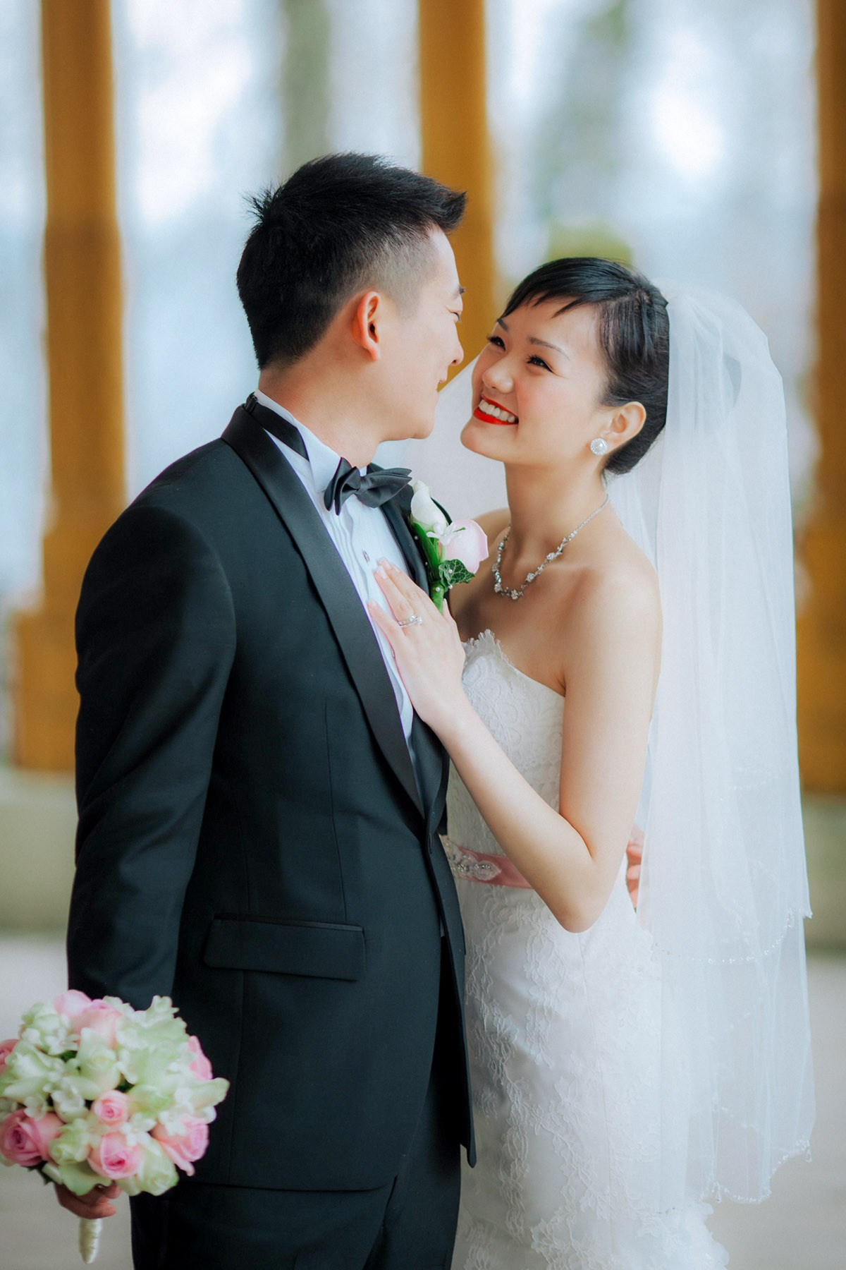 A joyful Hong Kong bride and groom enjoy a moment on the historic grounds of the State Chateau of Hluboka during their destination wedding in Bohemia.
