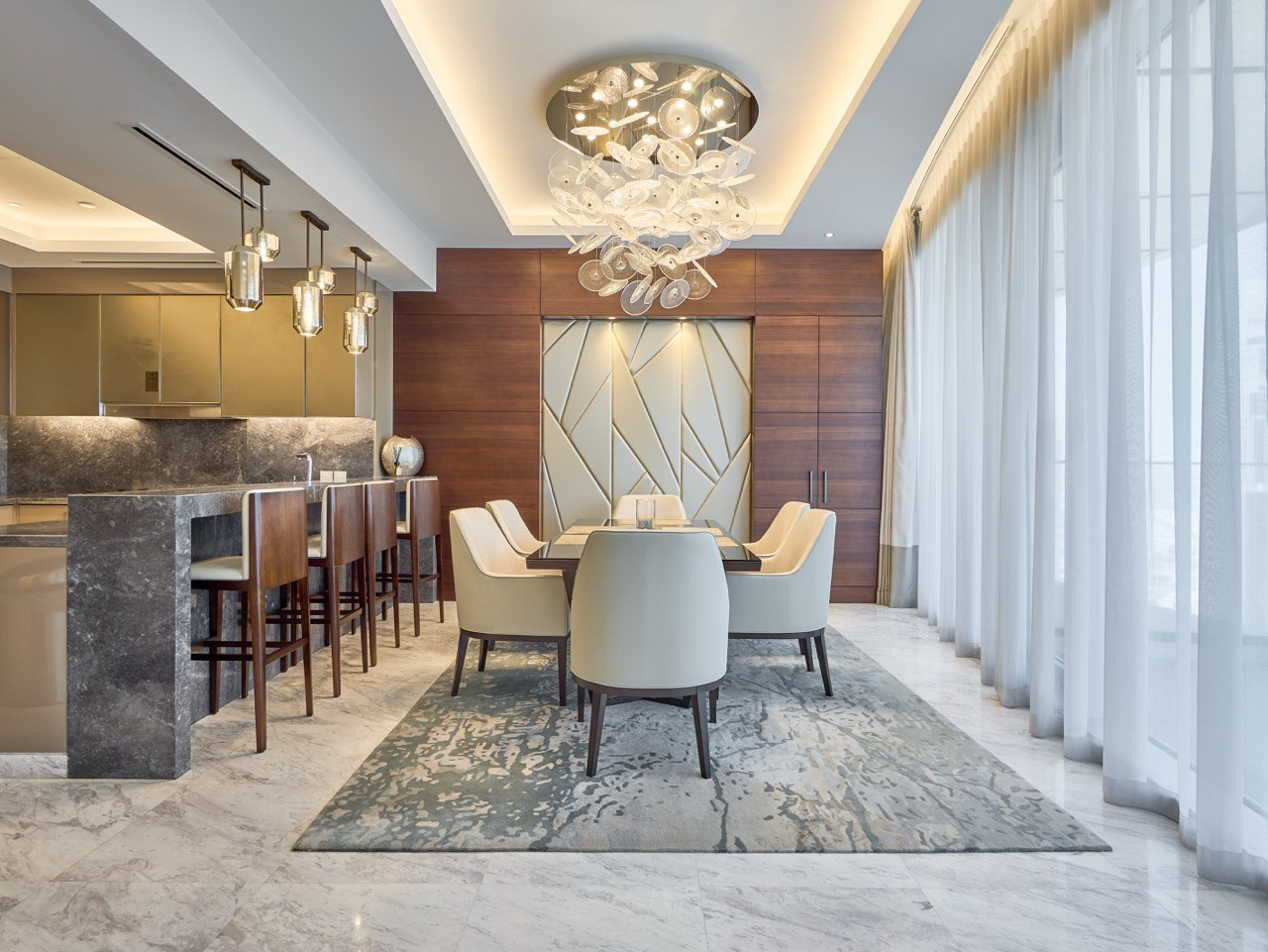 Elegant dining corner with soft light and marble floor, captured by hospitality photographer.