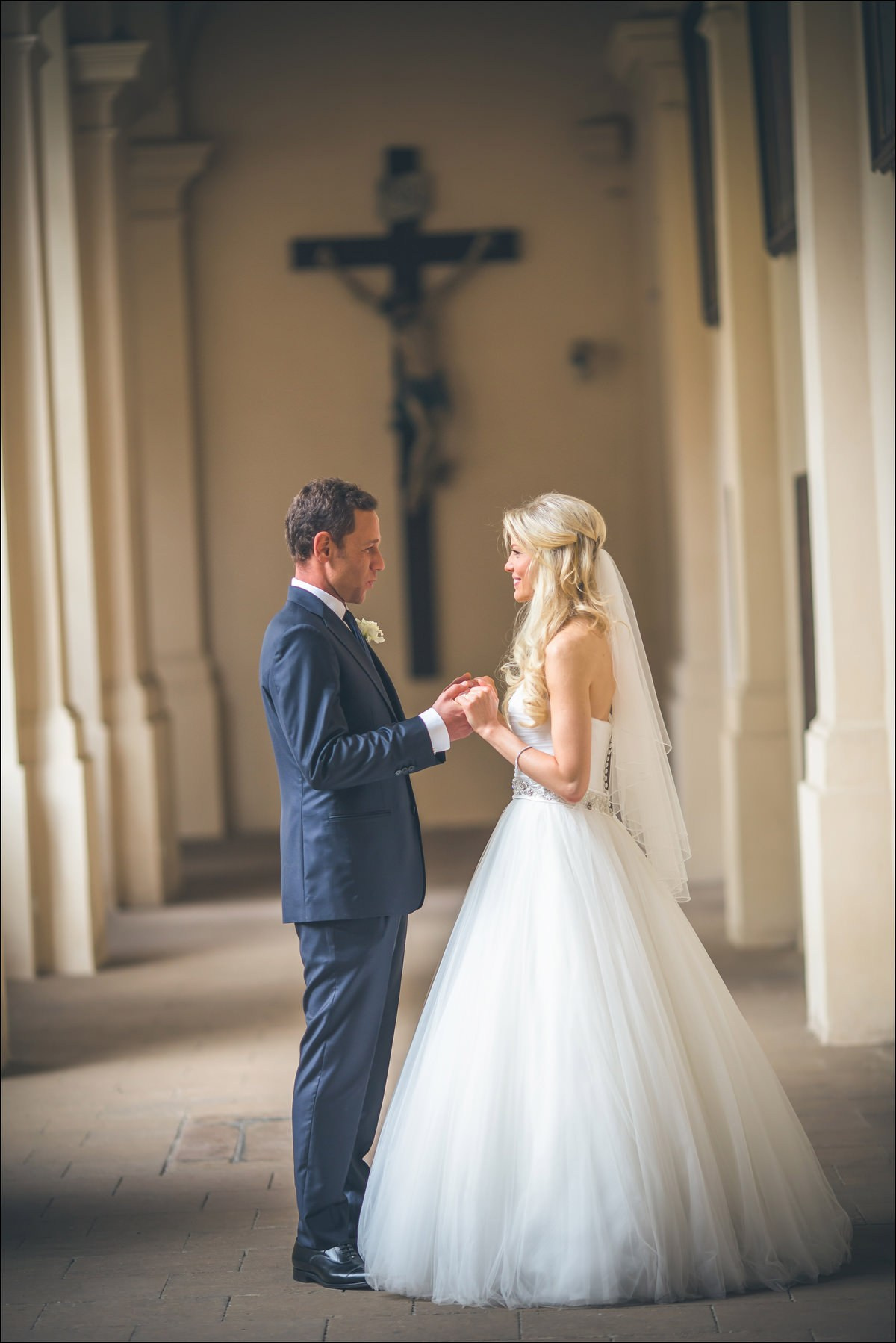 Quiet moment for newlyweds under cross at St. Thomas Church Prague