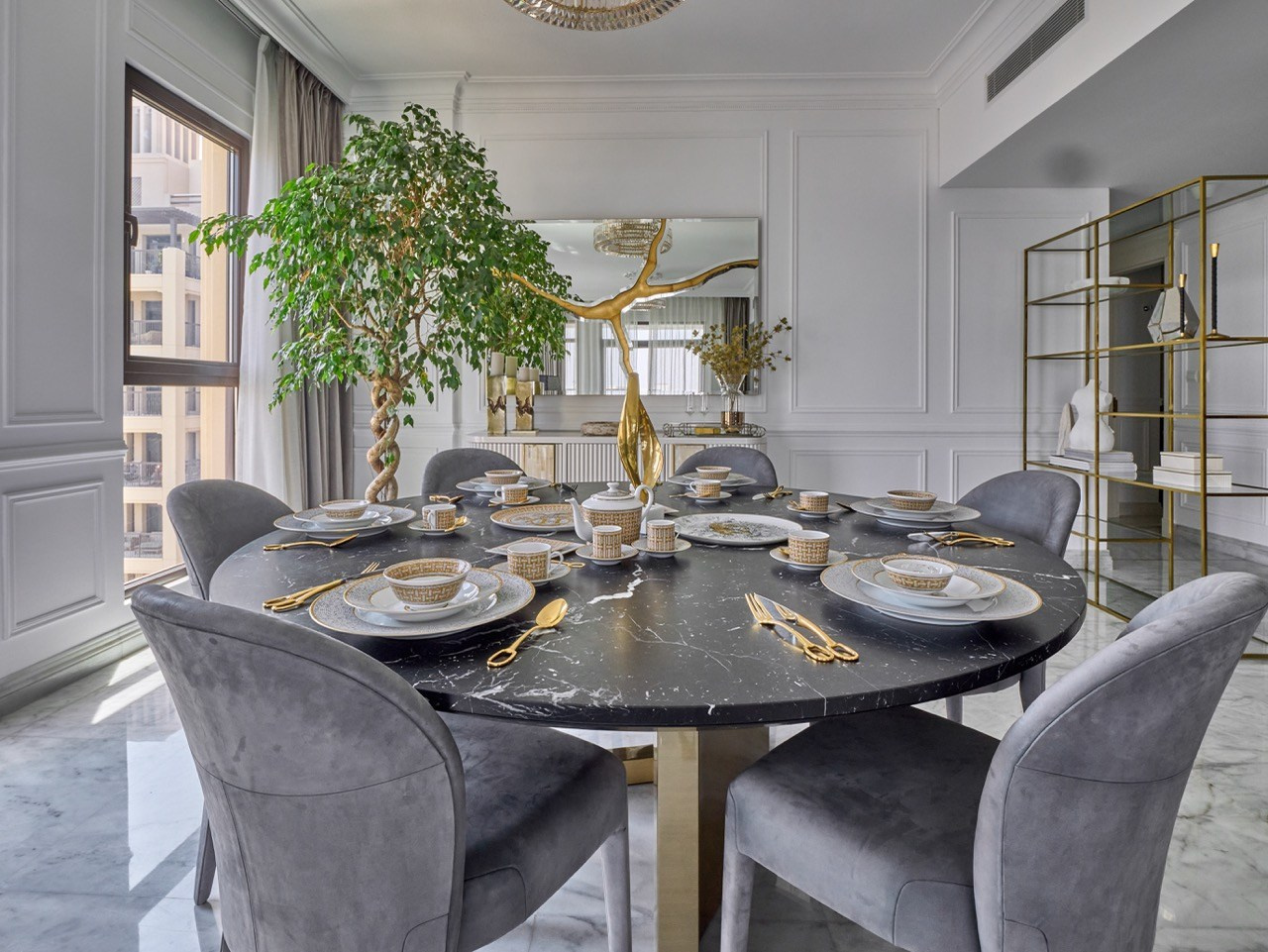 Luxury dining room with black marble table and grey chairs, by interior and real estate photographer.