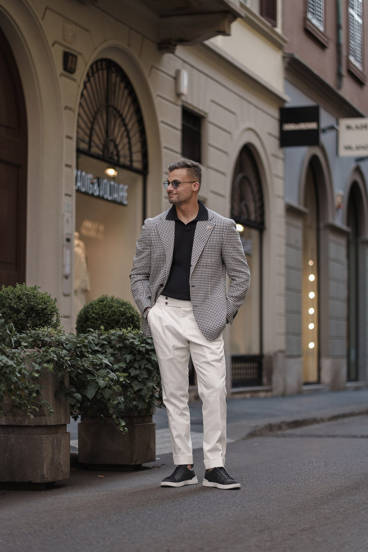 Jamal posing on an elegant shopping street during a Milan photoshoot