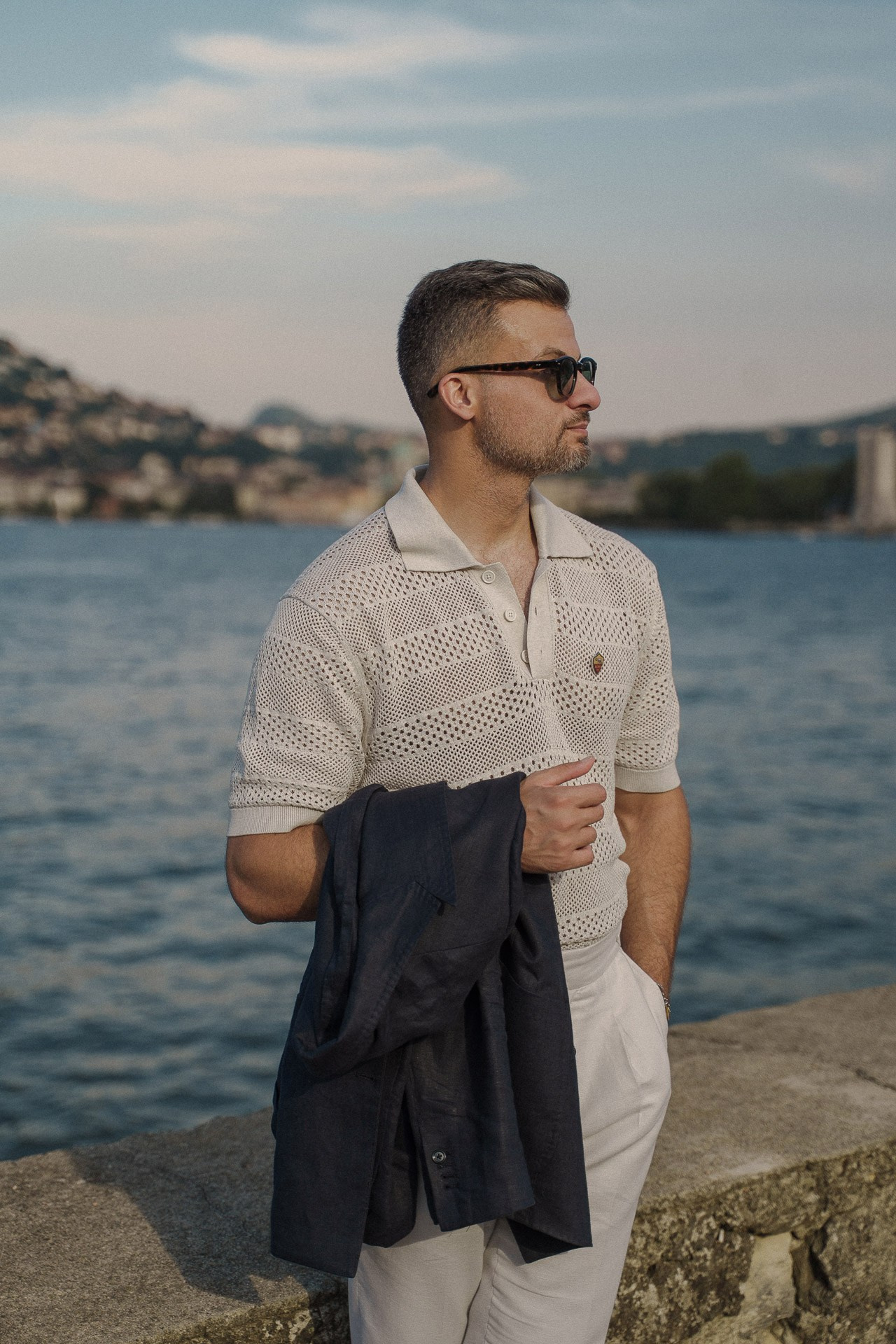 Relaxed male portrait on the Como waterfront with a jacket in hand