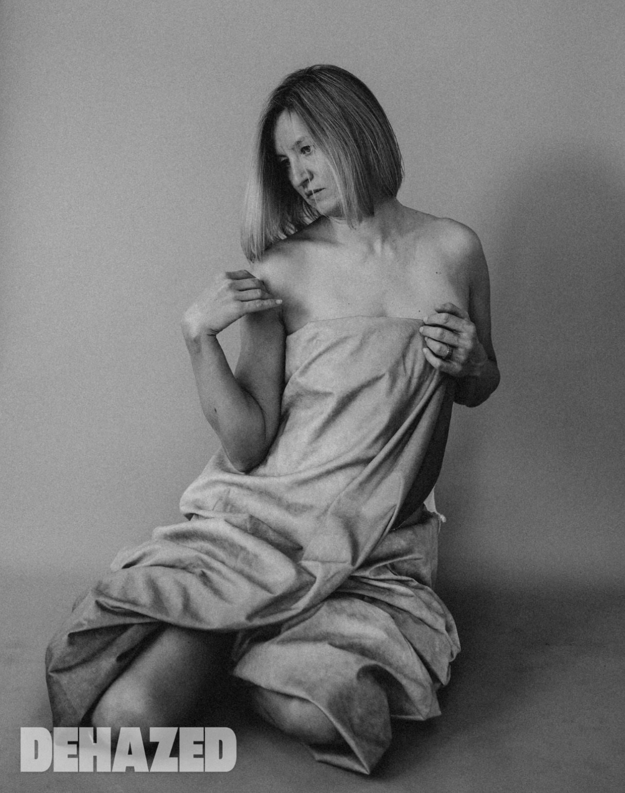 Fine art boudoir photograph of a seated woman in fabric, editorial boudoir photographer West Midlands