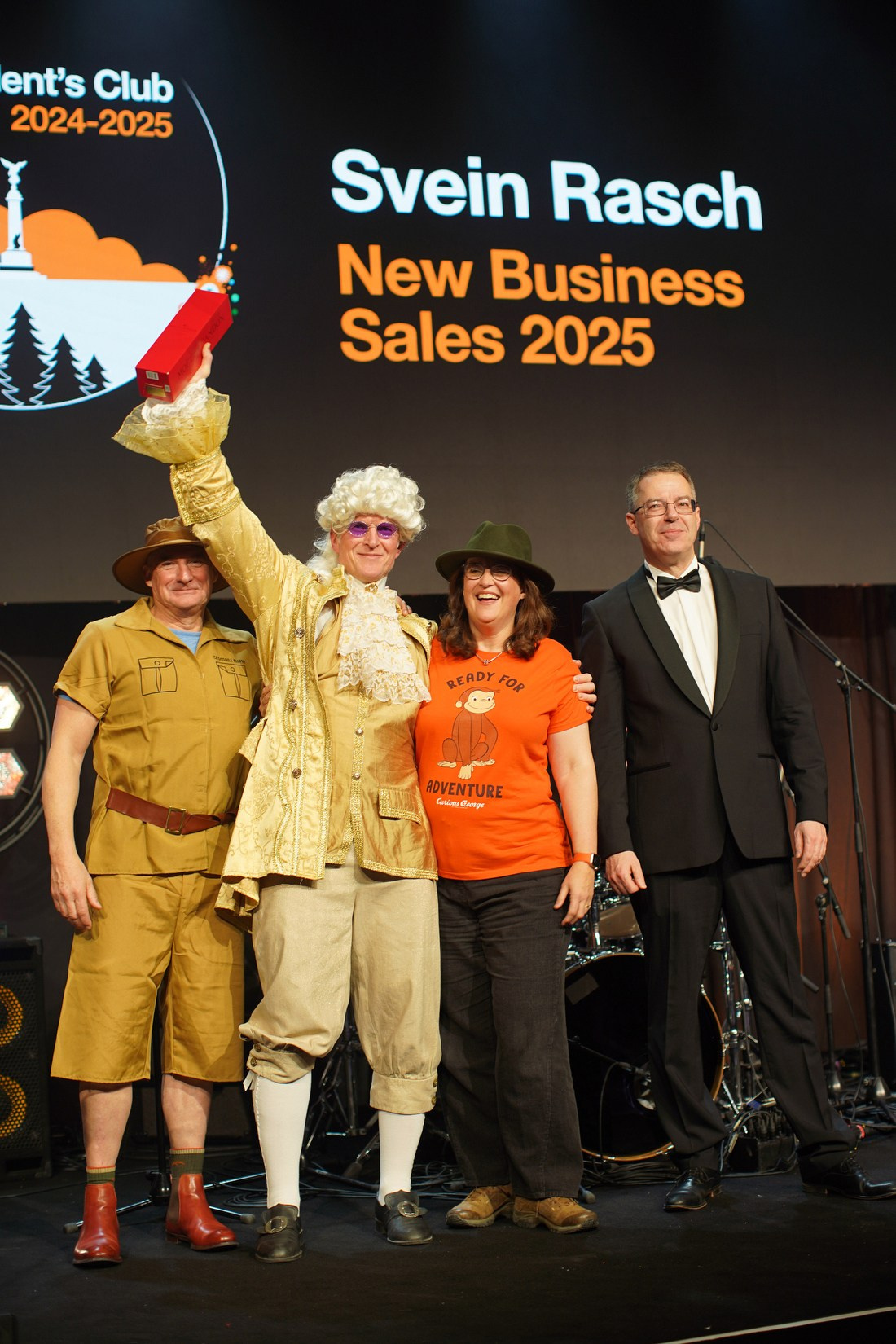 Orange Business award winner holding glass trophy on stage during European Sales Kick-Off gala Prague 2026.