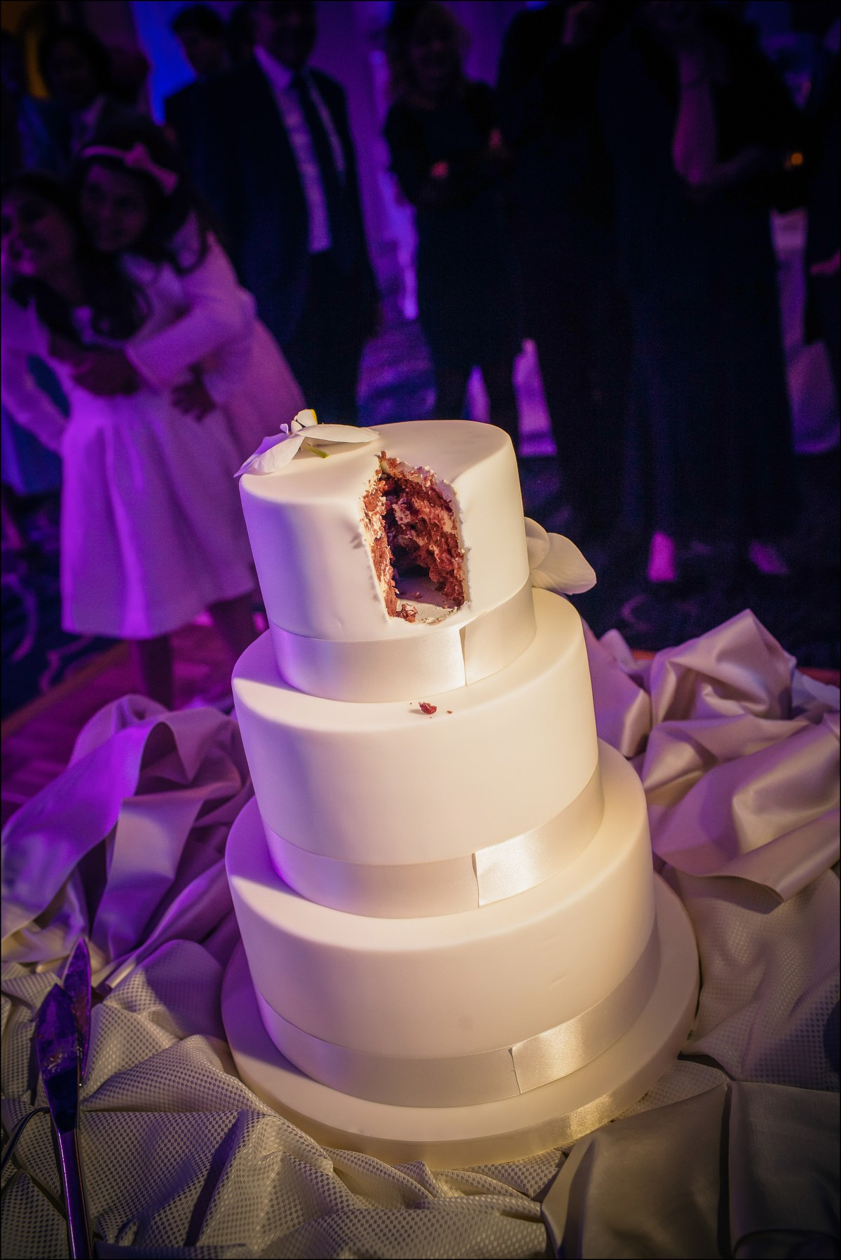 Three-tier wedding cake after first cut luxury Prague reception