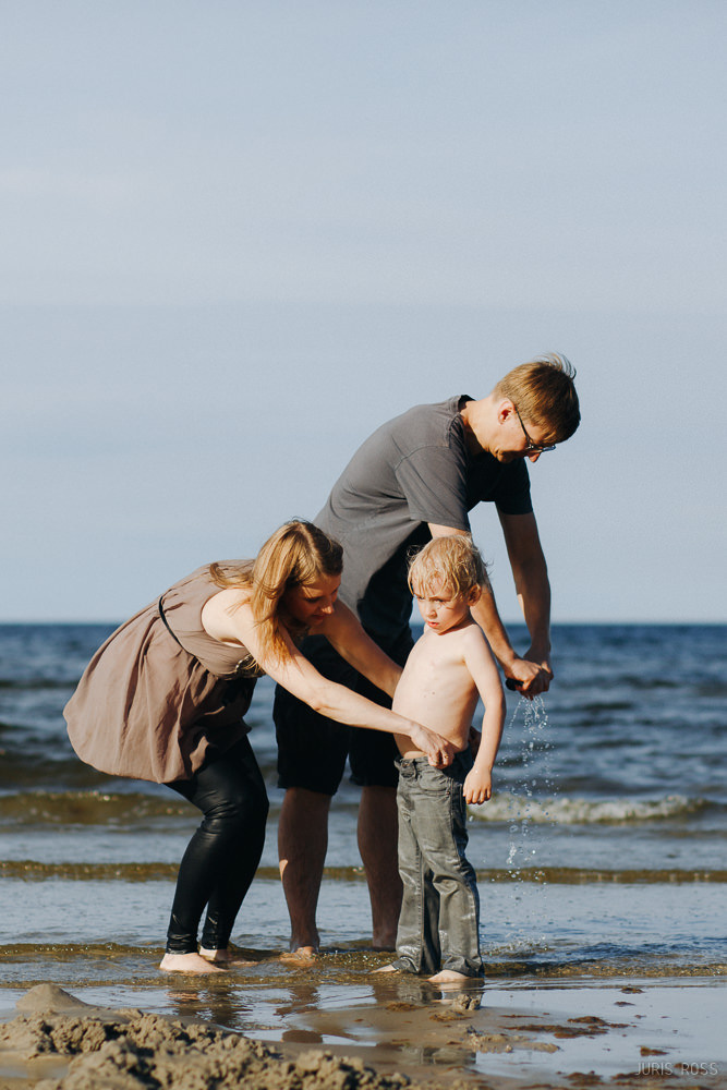 Ģimenes fotosesija pie jūras ar slapjām biksēm