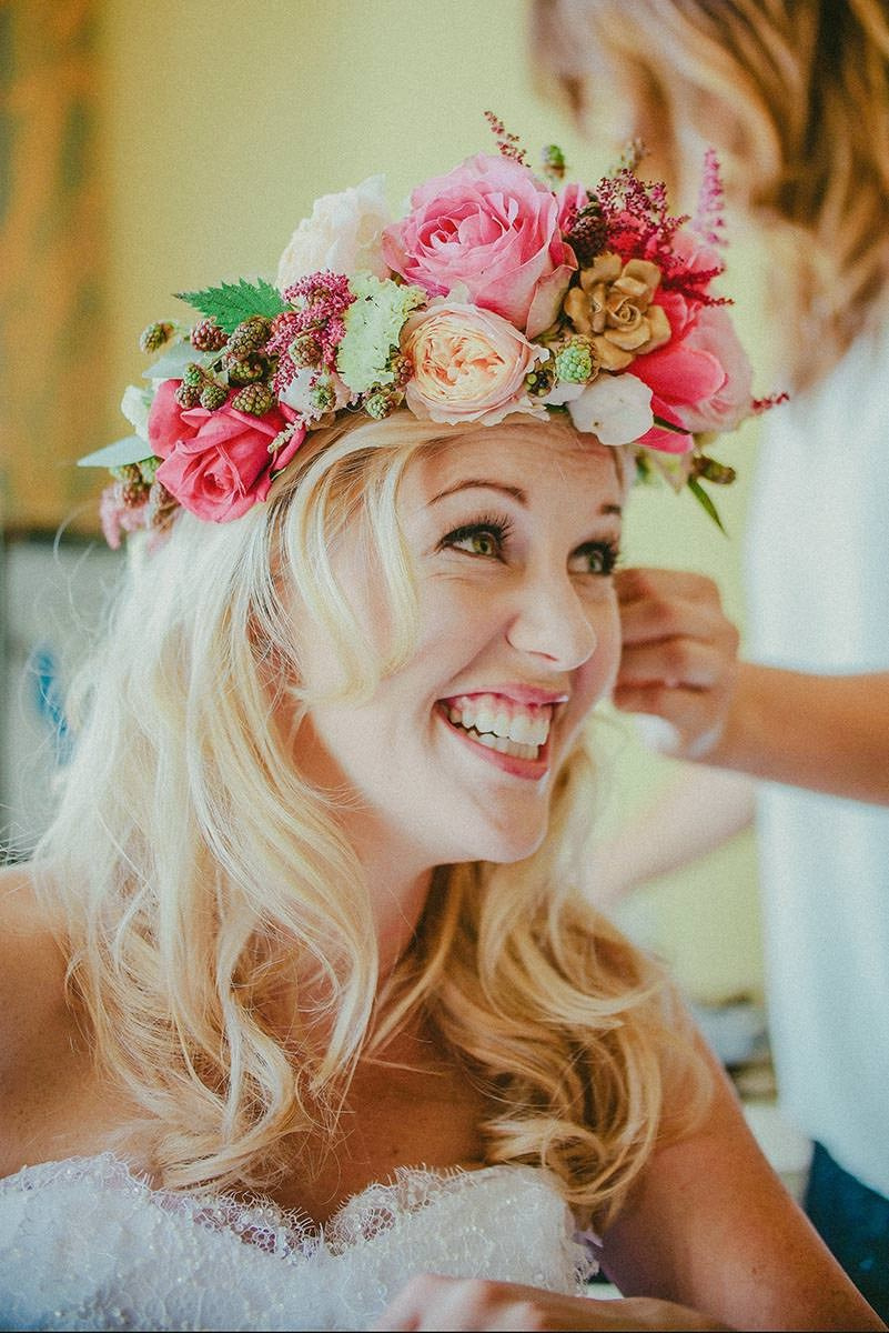 Radiant bride Michelle is smiling with her large floral headpiece