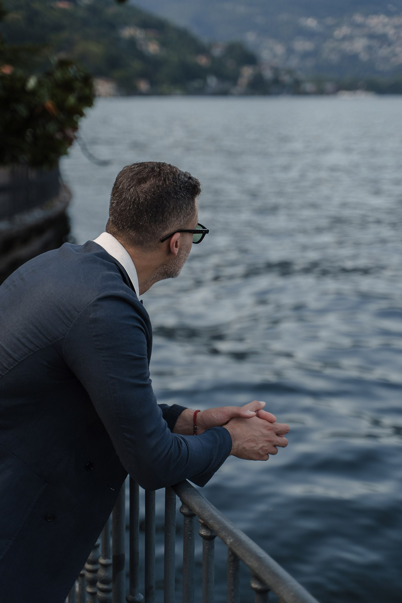 Jamal looking across Lake Como from the waterfront promenade