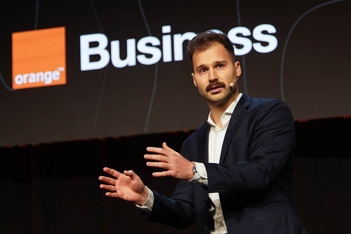 On stage action of a speaker during the 2026 Orange Sales Kick-Off, Hilton Prague, 2026.