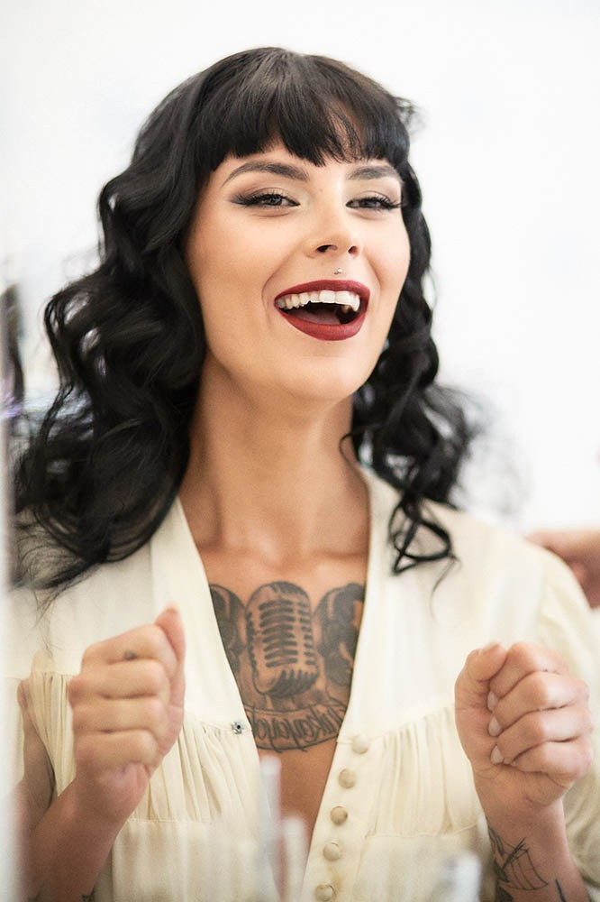 Canadian bride beaming during a professional hair styling session in Prague.