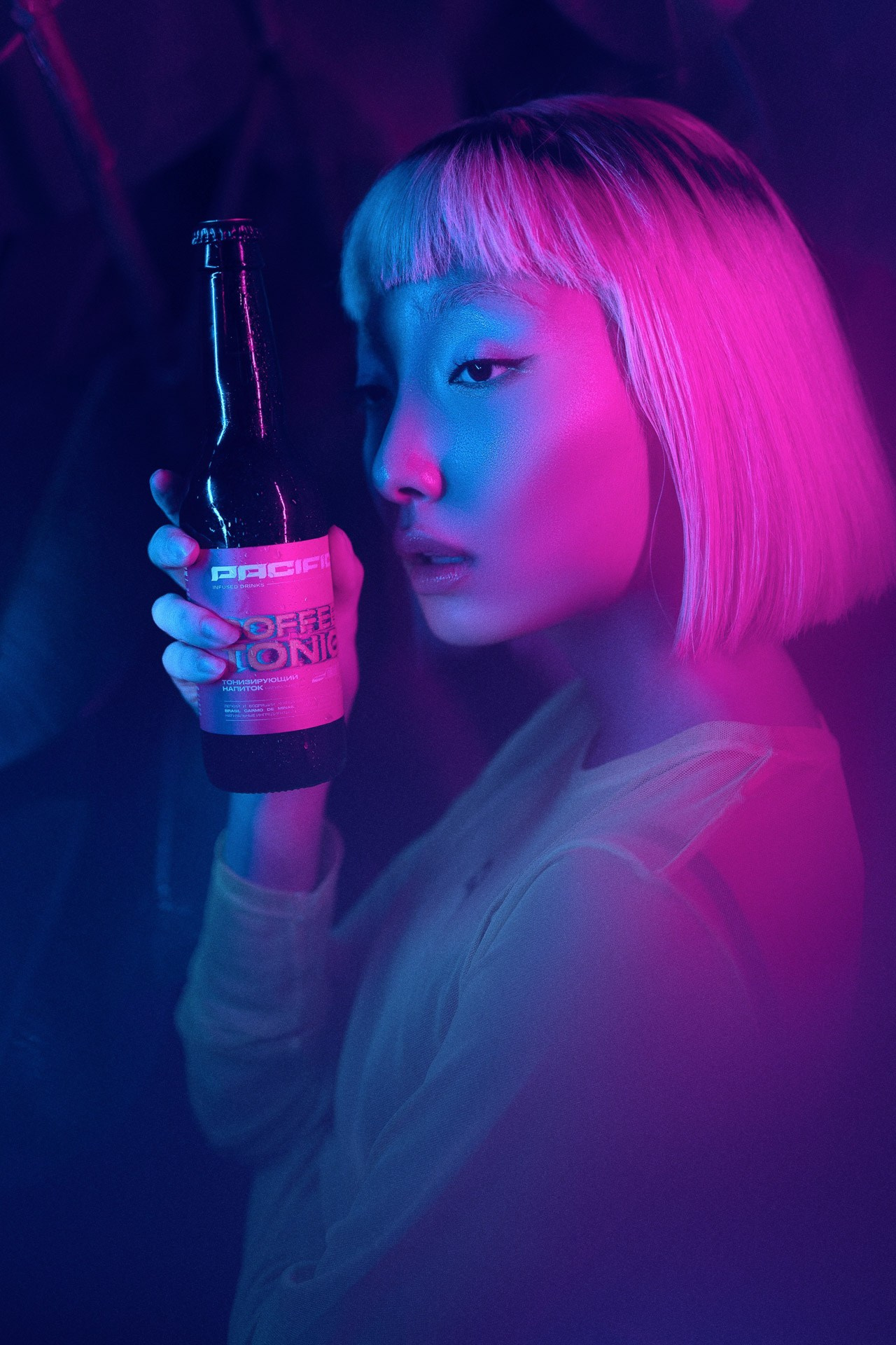 Creative portrait with neon lighting and colorful drink, commercial lifestyle photography
