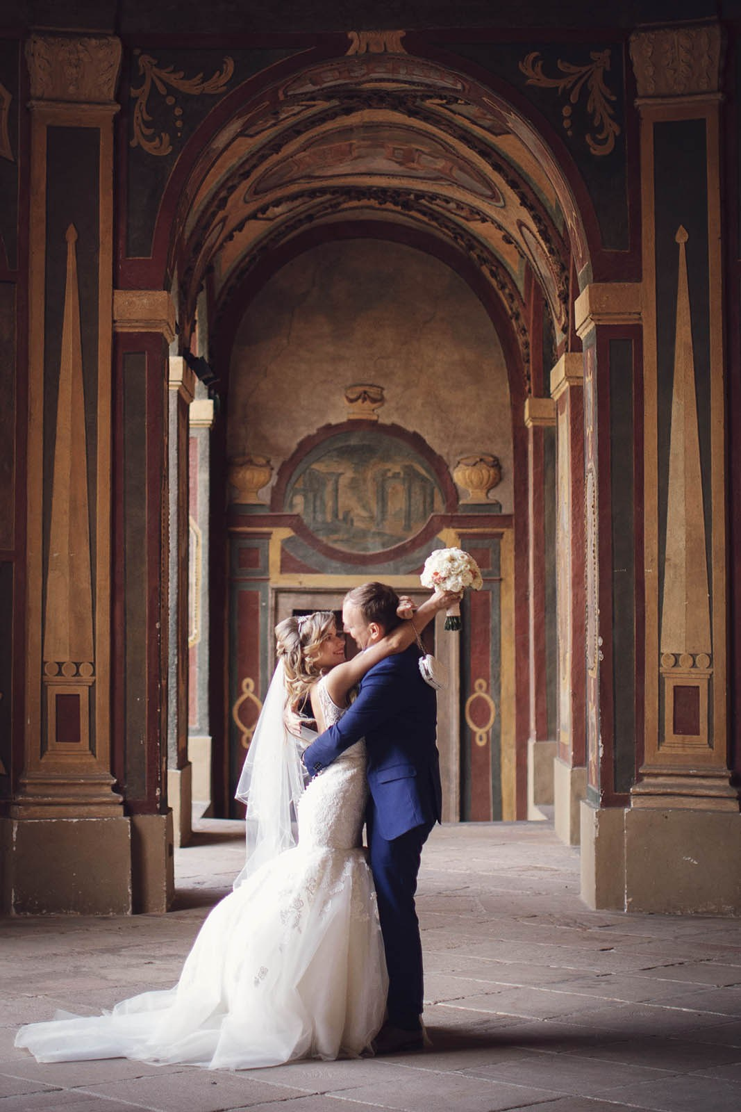 Bride and groom embrace in the Ledebour Garden, Sala Terrena on their wedding day