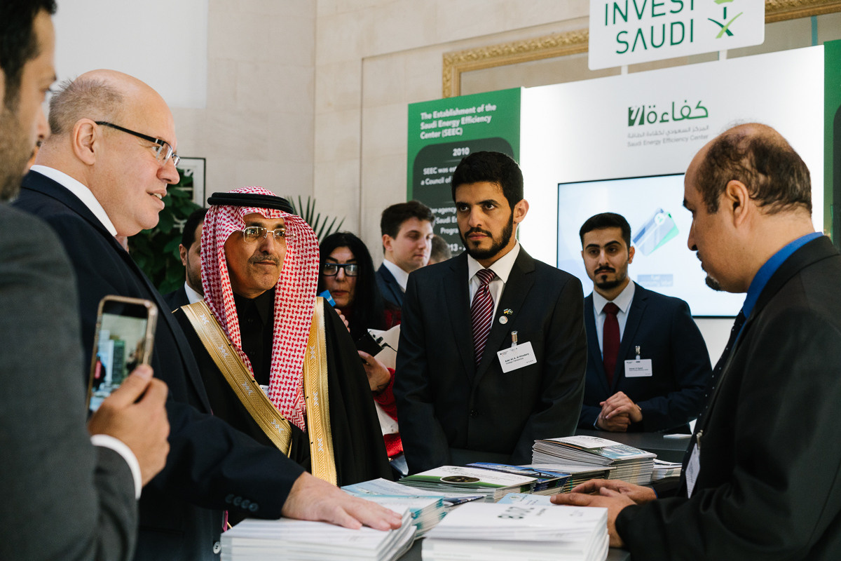 A delegation visits an exhibition stand and discusses projects during an economic cooperation event