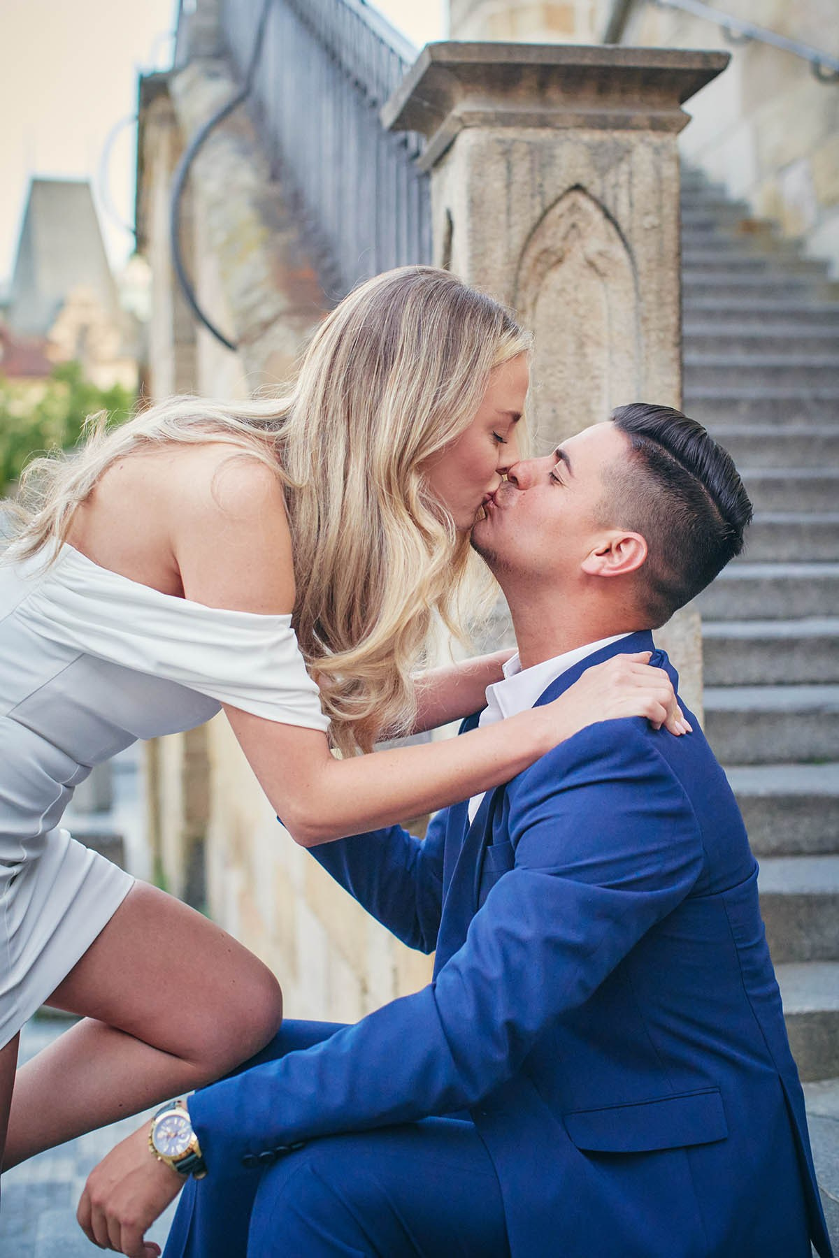 Flirty young couple on Kampa Island steps during a romantic morning shoot.