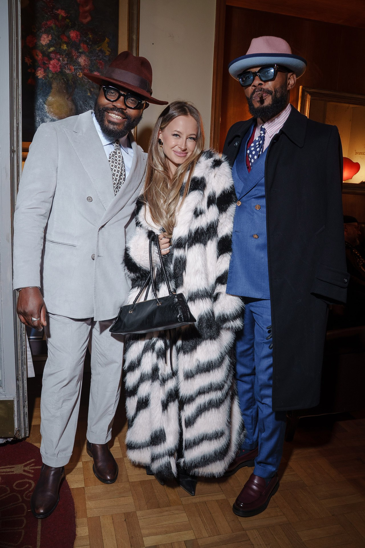 Stylish guests posing together at formal evening event