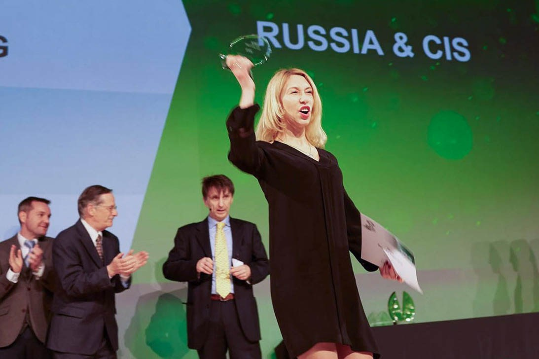 An awardee celebrates her accomplishment on stage, Bio-Rad gala.