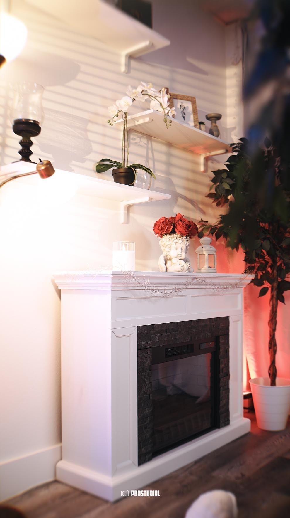Bright photo studio corner with fireplace and decorations at ProStudio1