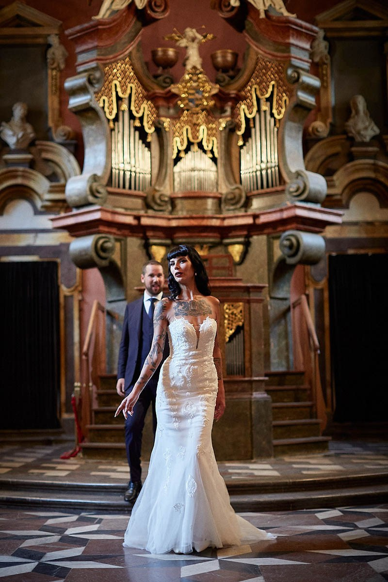 Burlesque bride catwalk pose in front of a loving groom chapel.