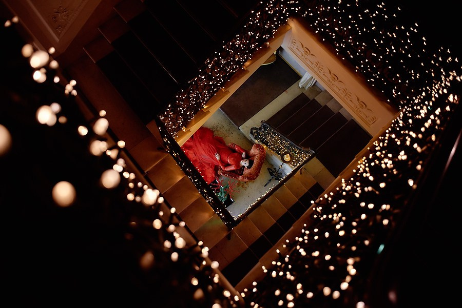 Couple on staircase with fairy lights — luxury wedding photography in Dubai and destination