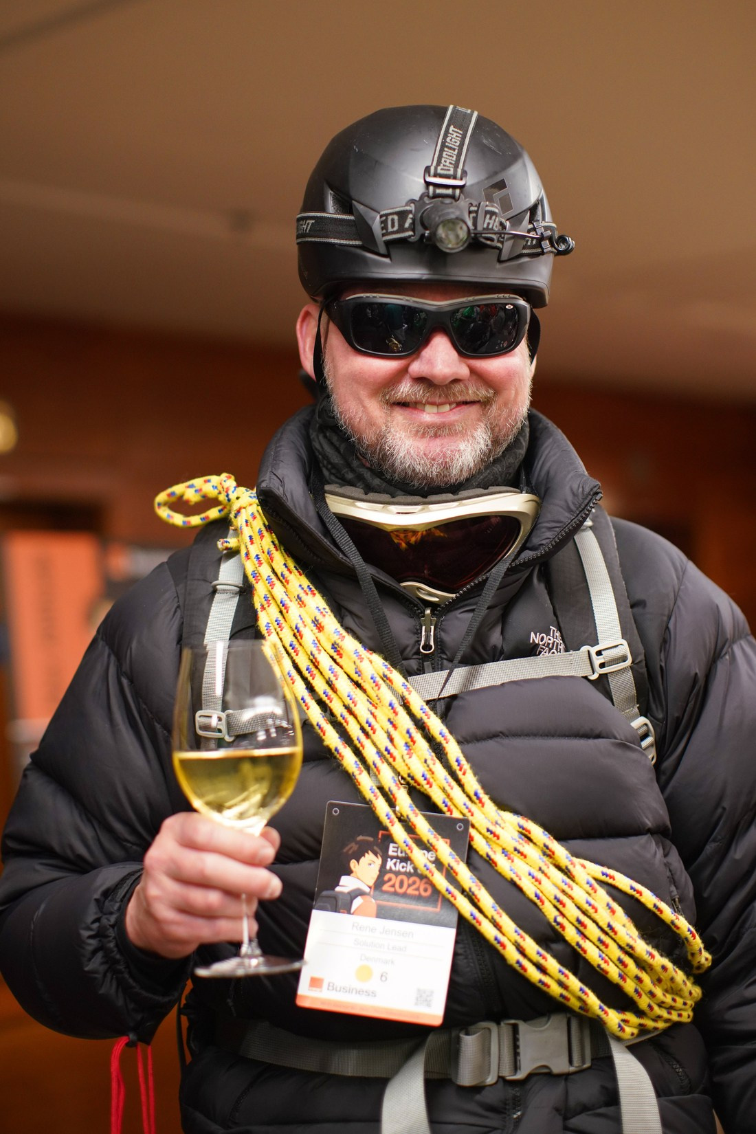 Corporate attendee with wine glass at adventure-themed gala dinner Orange Business Sales Kick-Off Hilton Prague.