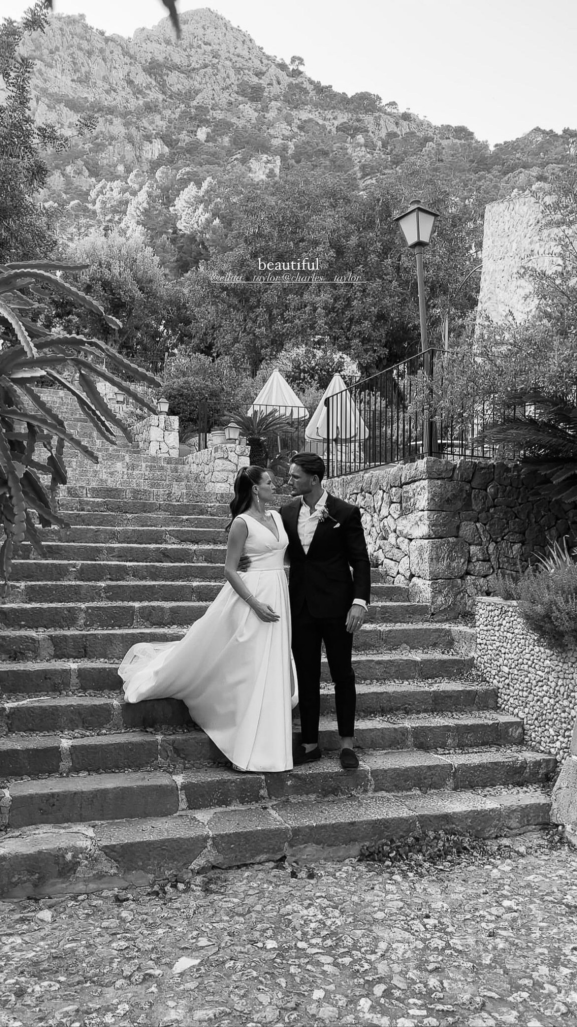 Bride and groom embracing on stone steps at their Alqueria Blanca wedding venue in Mallorca