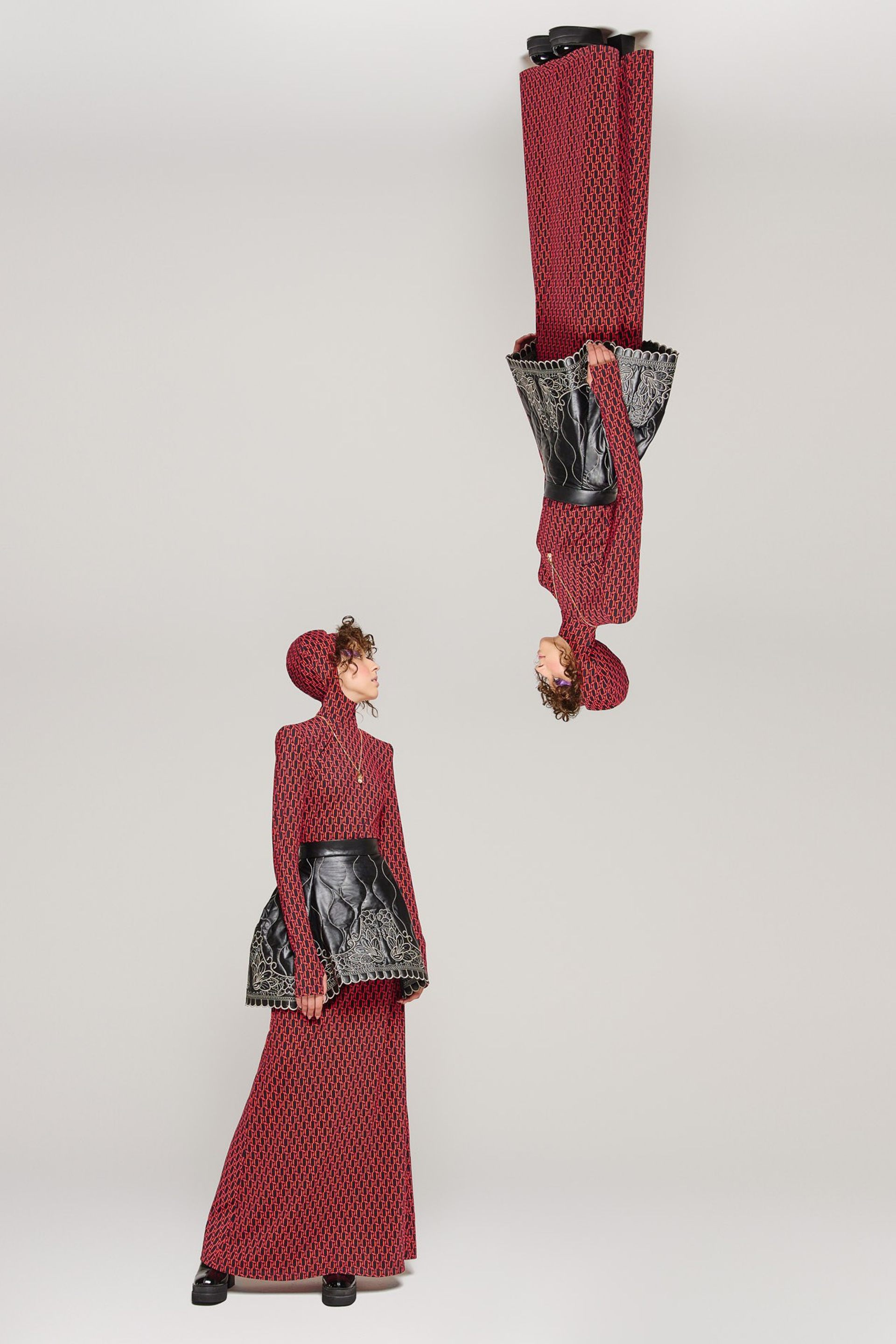 Conceptual fashion portrait with mirrored red outfit and graphic composition