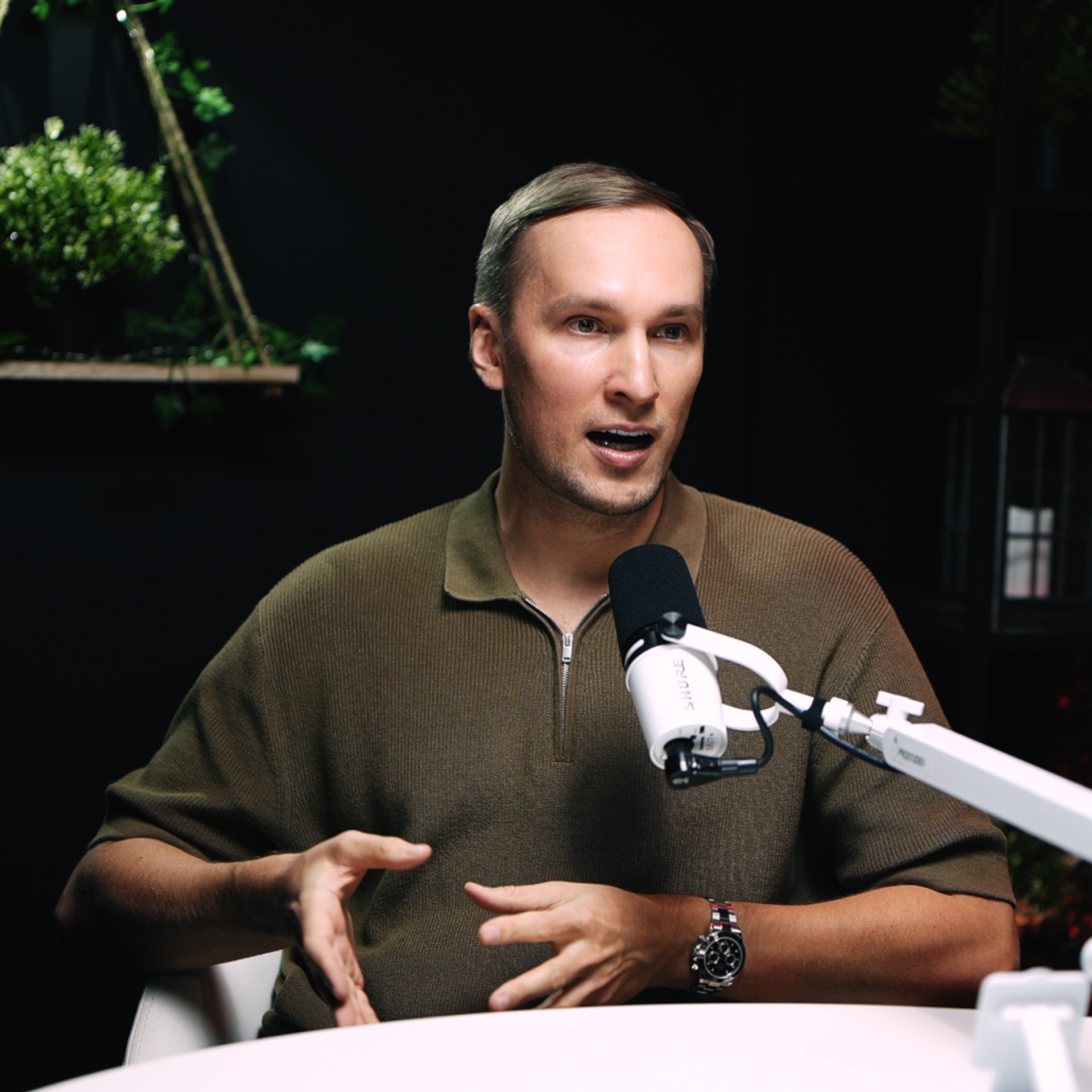 Close-up interview shot at ProStudio1 in Hollywood, Florida — guest on camera with studio microphone in the talk-show podcast set.