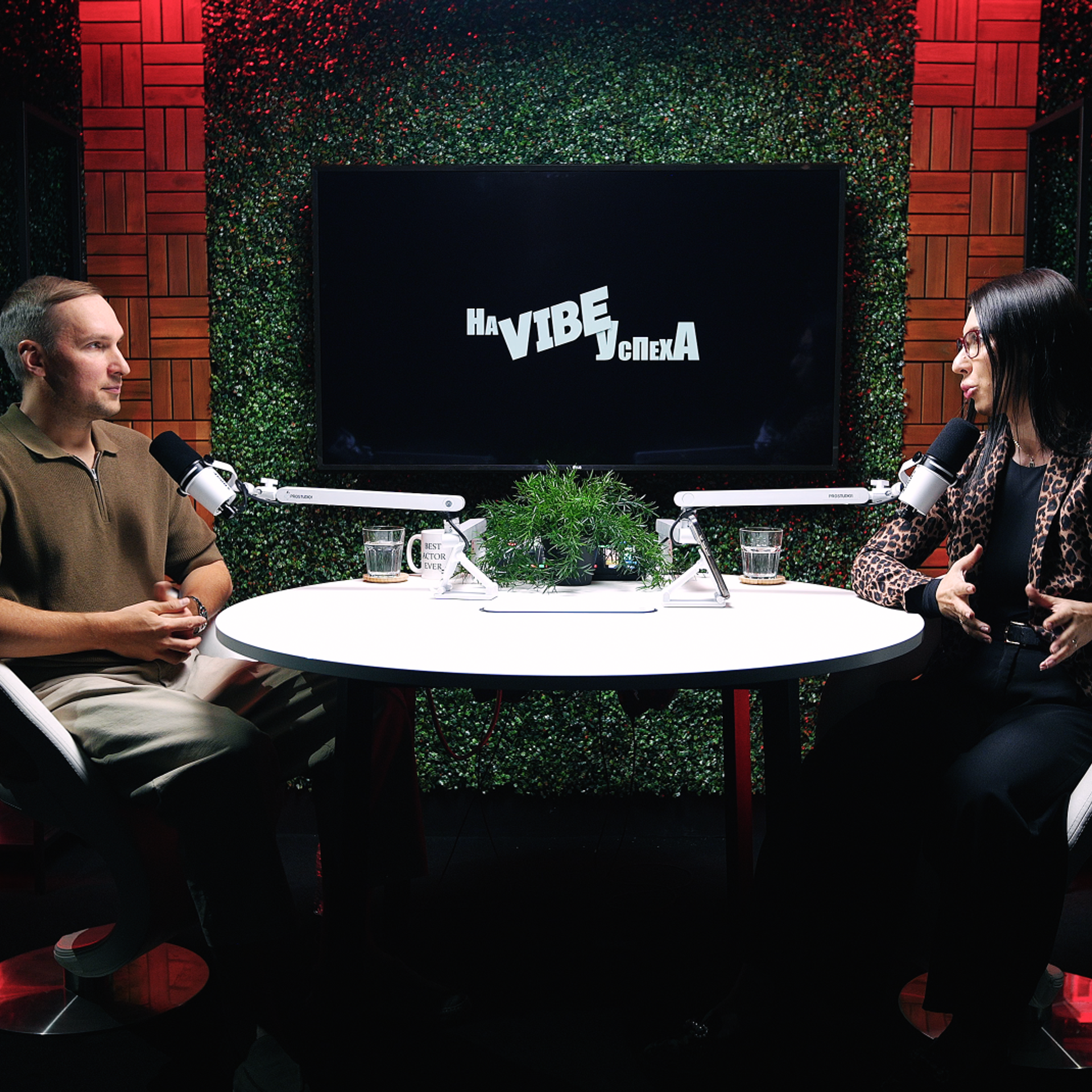 Talk-show podcast table at ProStudio1 in Hollywood, FL — wide shot of round-table interview set with professional microphones and cinematic lighting.