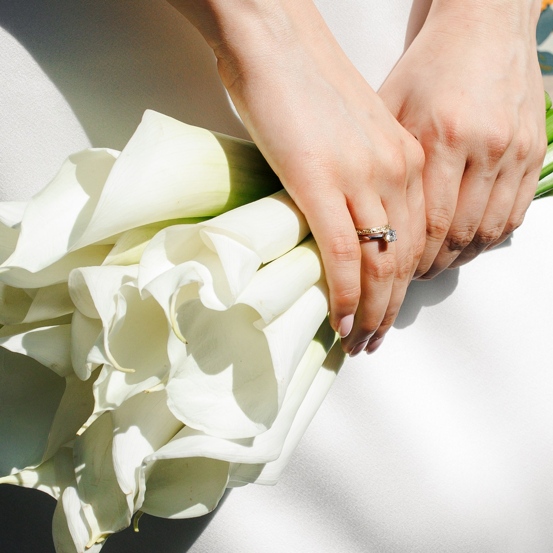 Close-up shot of the engagement ring and bridal flowers