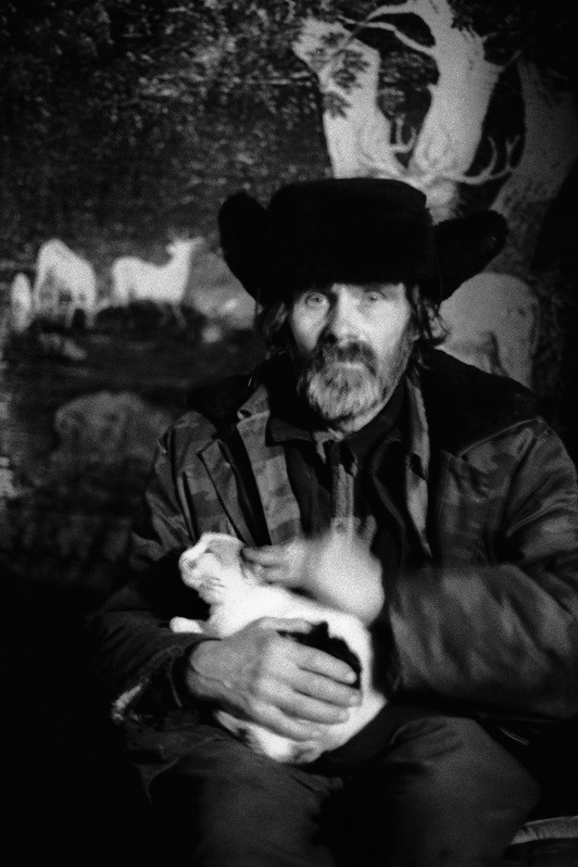 The watchman Zhenia with a cat on hands, Bykovsky khutor, Verhnedonsk district, Rostov-on-Don region, Russia. January 2011