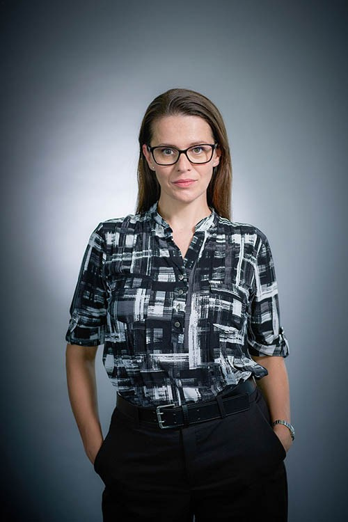Professional headshot photography in Prague — clean on-location executive portrait against a seamless grey background.
