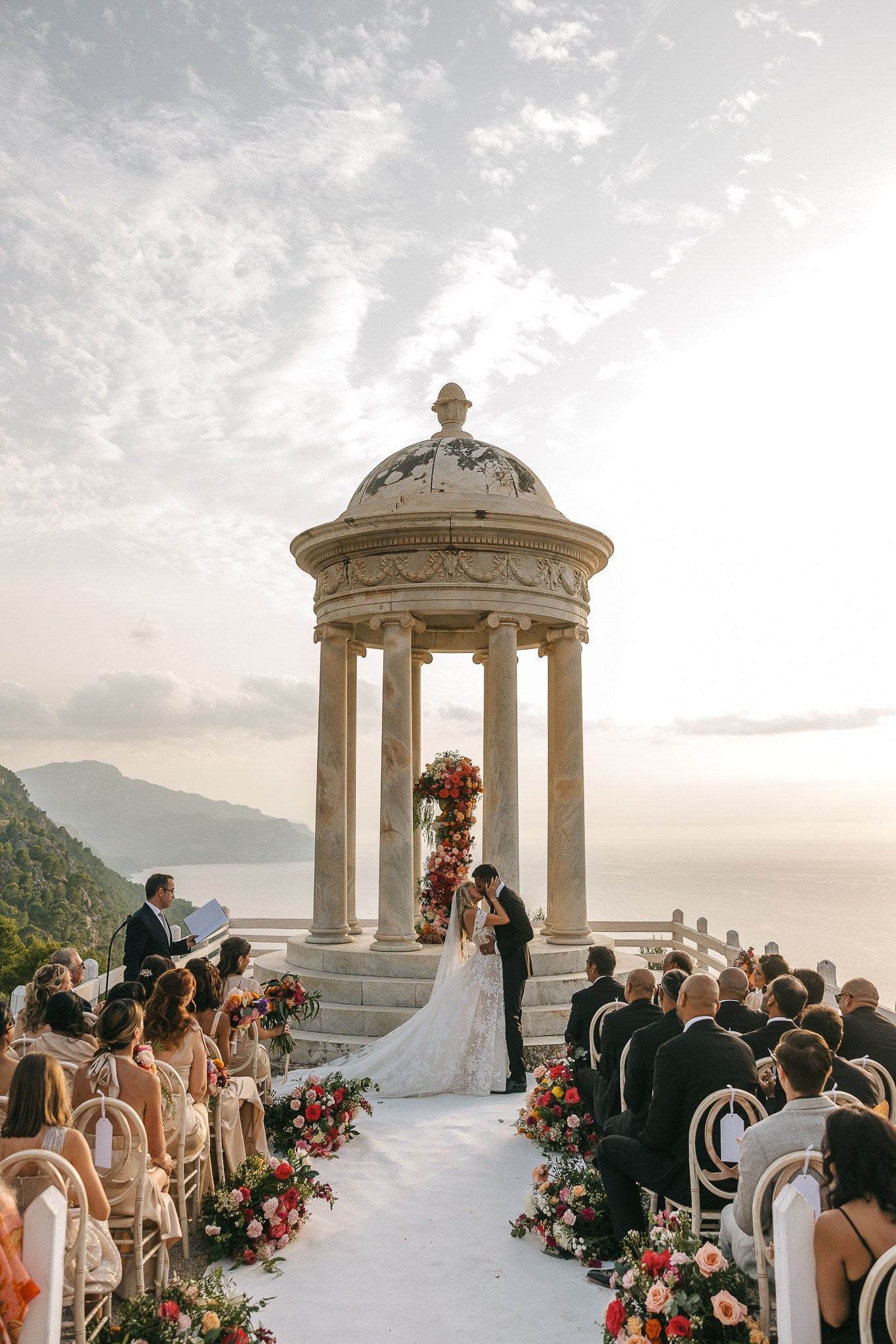 Bride and groom sharing their first kiss as newlyweds at Son Marroig, Mallorca