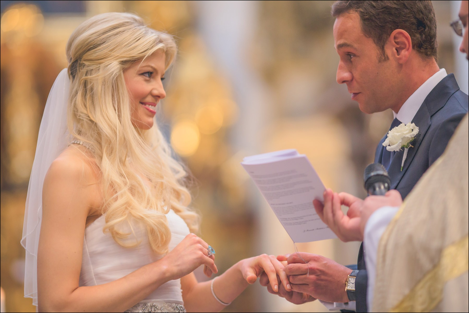 Groom reading personal vows to bride during Prague church wedding