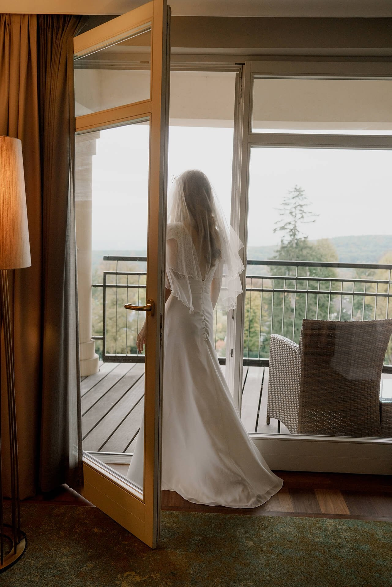 Bride in gown at balcony doors, Falkenstein Grand wedding portraits