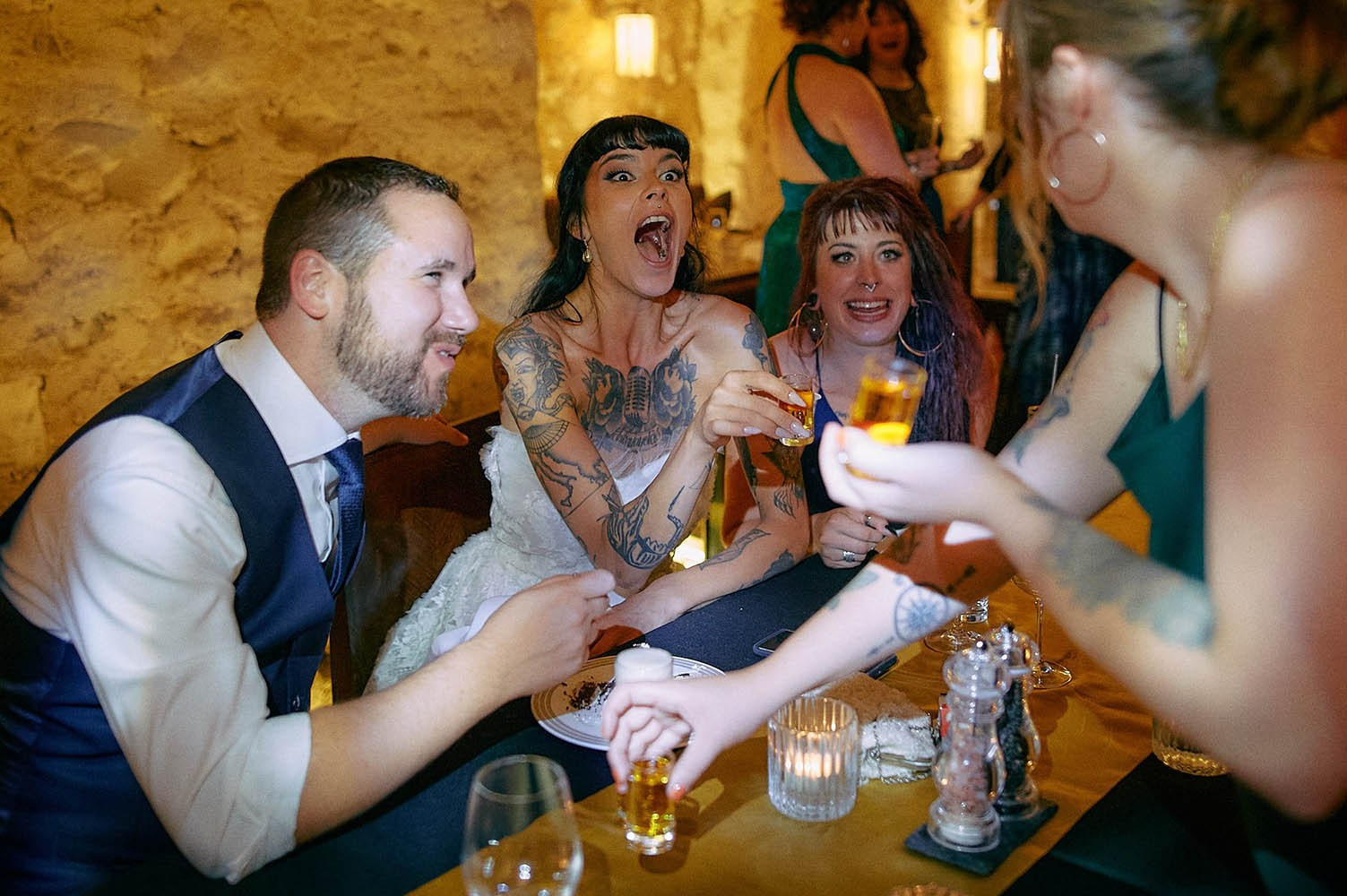 Fresh shots delivered to table at lively brewery bar reception.