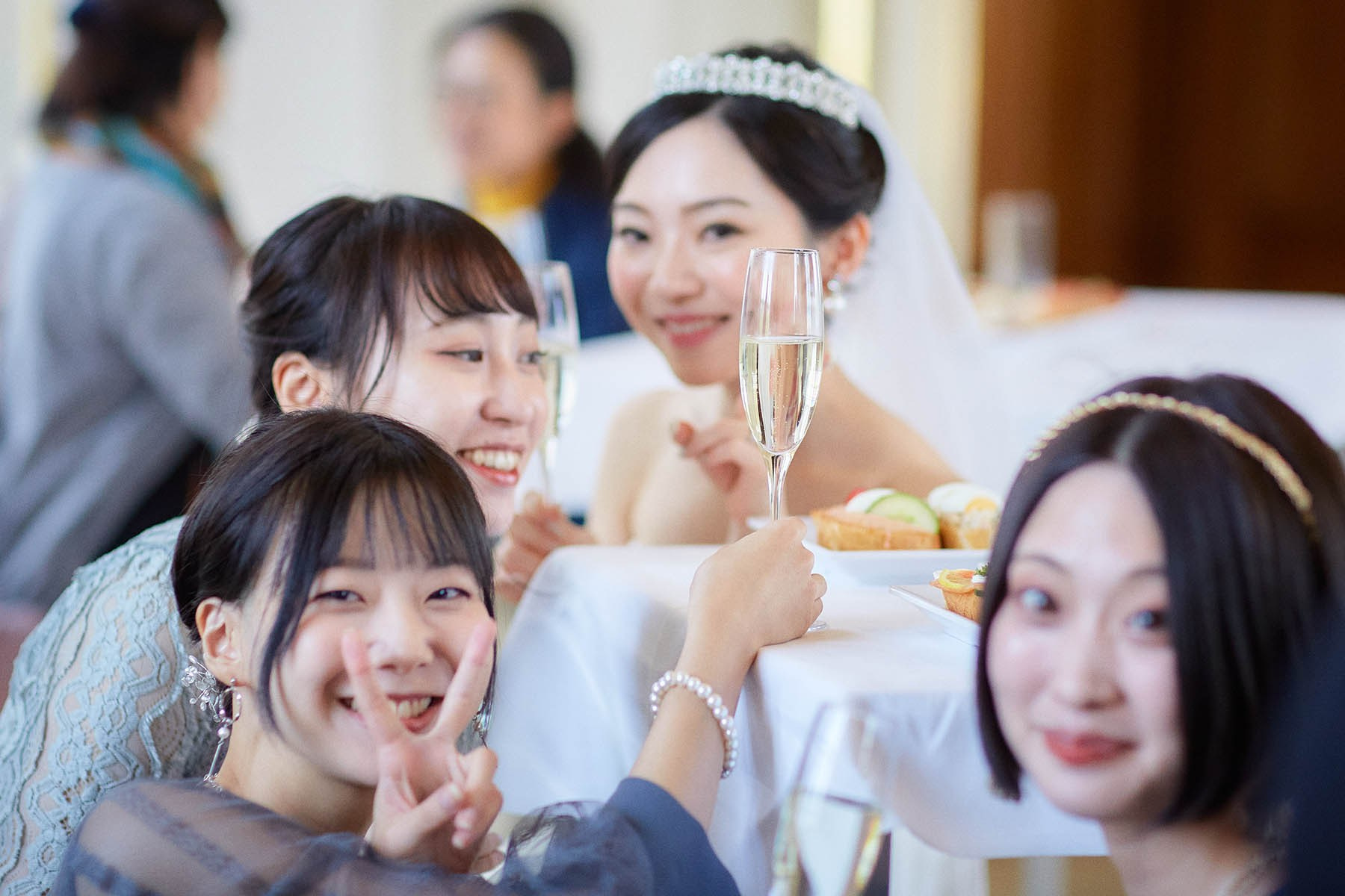 Bride and friend holding up champagne glasses for photo Vienna wedding.
