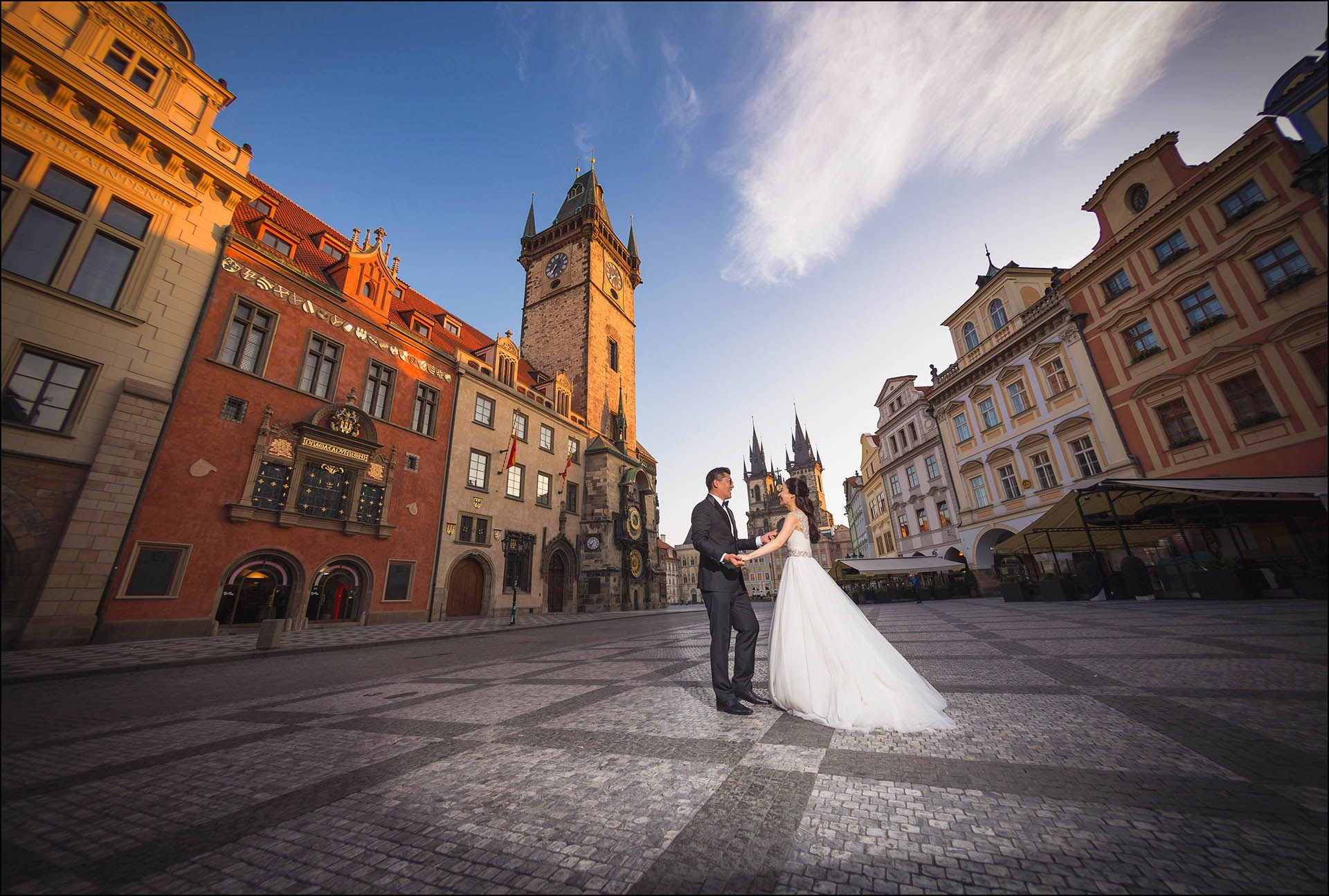 Catherine Cedric Son frolic Old Town Square dawn Prague wedding portrait.